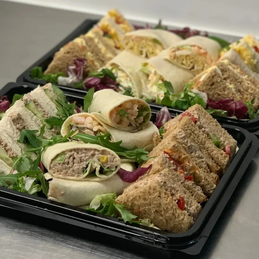 Homepage 4 Gourmet filled wraps and sandwich triangles with fresh salad garnish for corporate catering in Bedfordshire by Xpress Catering