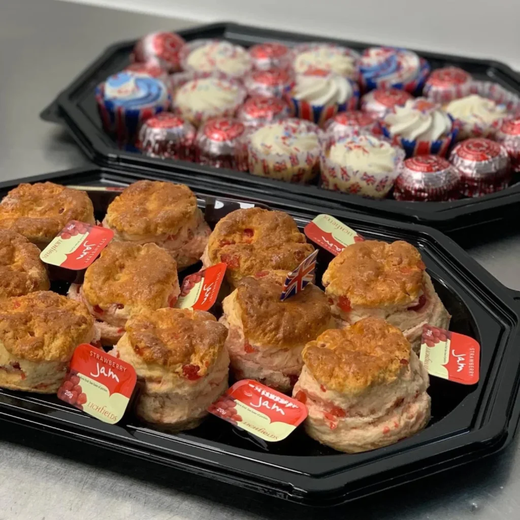 Homepage 8 Luxury dessert platter with iced donuts, Danish pastries, rainbow cake, fresh fruit and Union Jack decoration by Xpress Catering Bedfordshire